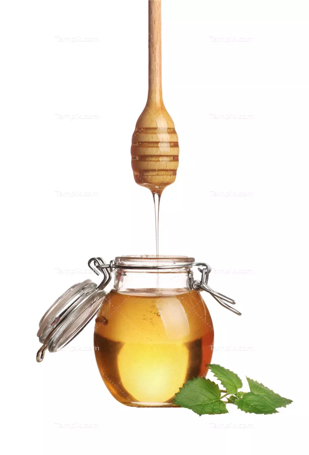 عکس دوربری برگ آووکادو و ریختن عسل از قاشق چوبی مخصوص داخل شیشه عسل زنبور عسل