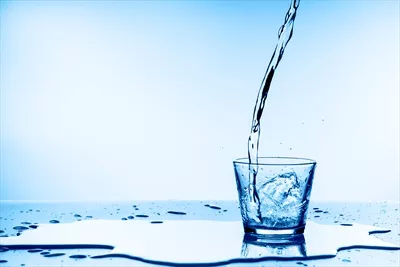 عکس ریختن آب در لیوان و روی زمین