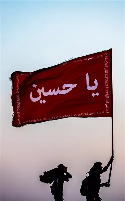 عکس پرچم یا حسین در دست زائر امام حسین کربلا