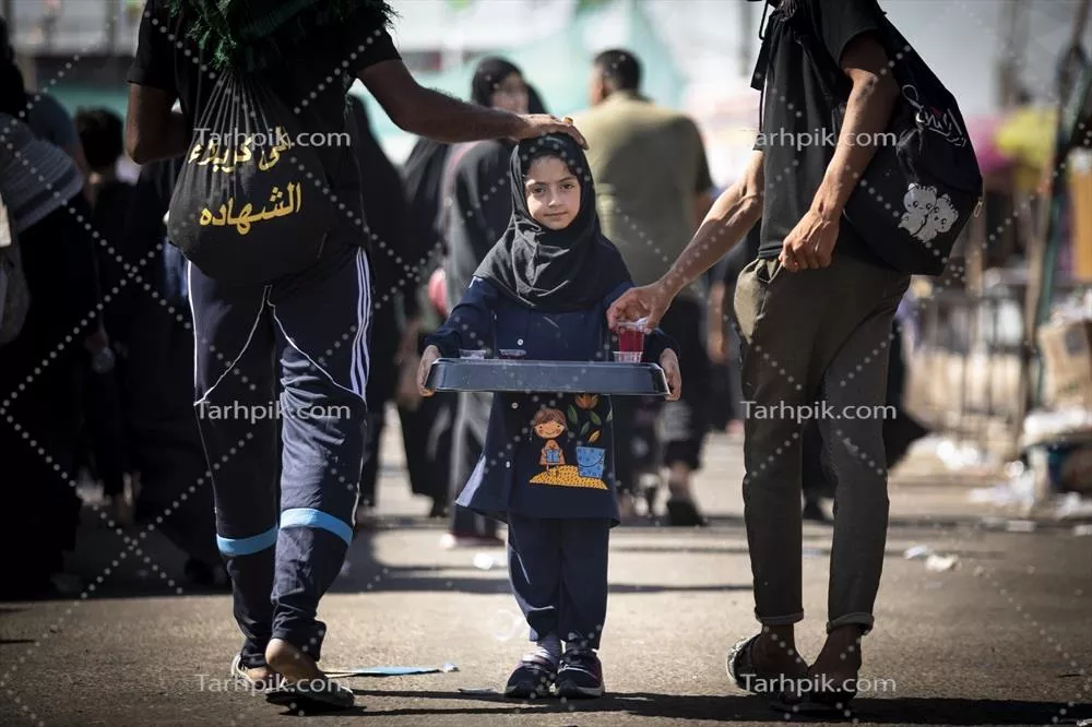 عکس دختر بچه در حال پذیرایی از زائران کربلا