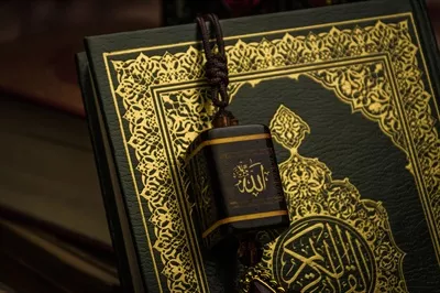 عکس تصویری از قرآن به عنوان کتاب مقدس مسلمانان بر روی میز