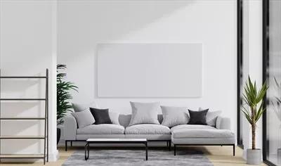 عکس تصویری از یک اتاق مینیمالیستی با مبل خاکستری و گیاه در آن