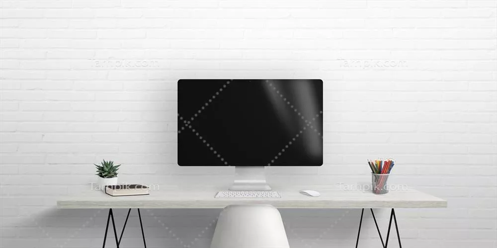 عکس تصویری از یک مانیتور کامپیوتر روی میز کار با دیوار آجری در پس زمینه