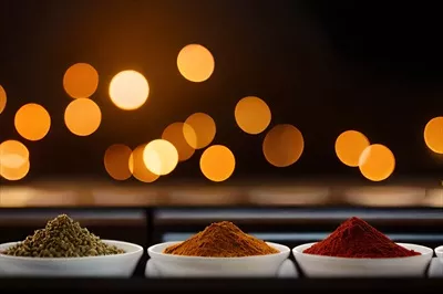 عکس چیدمان ادویه جات در کاسه ها بر روی میز با شمع های روشن در پس زمینه