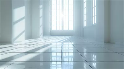 عکس اتاق بزرگ و خالی با دیوارهای سفید و کف کاشی کاری شده که با نور خورشید روشن شده است