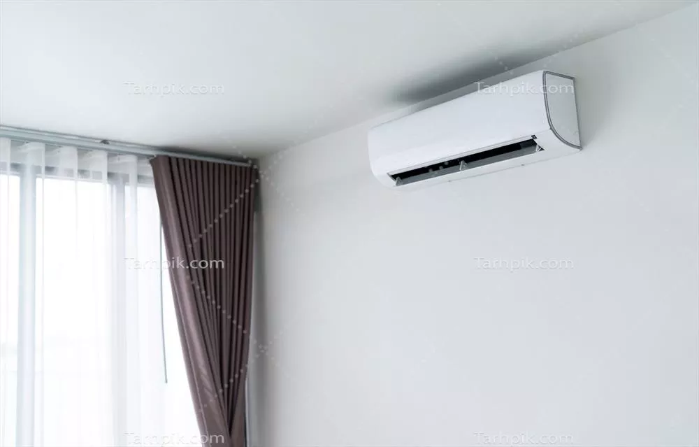 عکس تصویری زیبا از کولر گازی نصب شده بر روی دیوار سفید