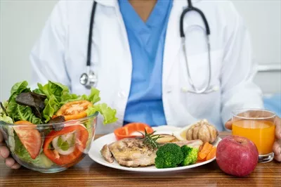 عکس متخصص تغذیه با انواع سبزیجات تازه و سالم برای مشاوره به بیماران