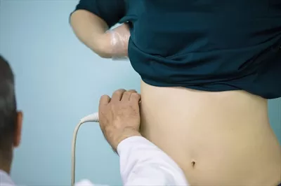 عکس پزشک در حال انجام تشخیص با سونوگرافی کلیه ها و بررسی وضعیت آن ها