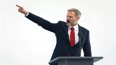 عکس مردی که با حرکات دست و لحن تند در حال سخنرانی است