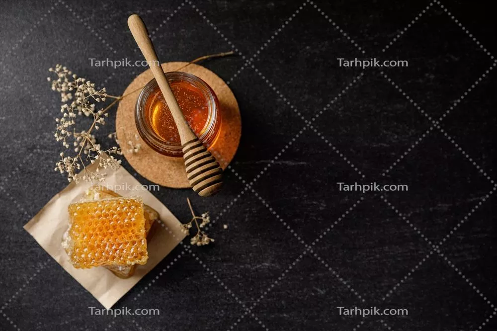 عکس عسل طبیعی و موم زنبور عسل با گل های خشک در پس زمینه سیاه