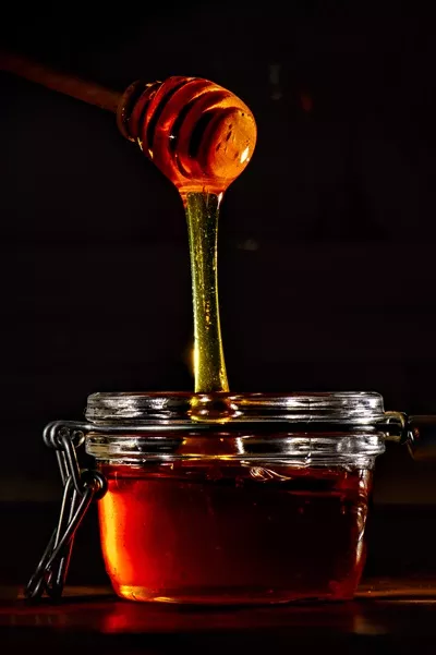 عکس عسل طبیعی با چوبی چوبی: لذت از طعم شیرین و خالص طبیعت