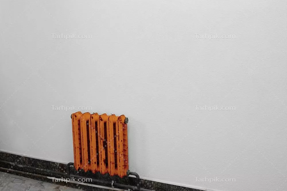 عکس رادیاتور نارنجی زیبا در برابر دیوار خاکستری: یک تصویر جذاب