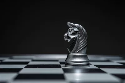 عکس صفحه شطرنج با مهره های شطرنج بر روی پس زمینه سیاه