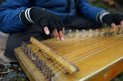 عکس مردی در حال نواختن کچاپی، موسیقی سنتی سوندانی در سیوی دی، جاوه غربی