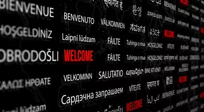 عکس خوش آمدگویی به زبان های مختلف با پس زمینه نقشه جهان