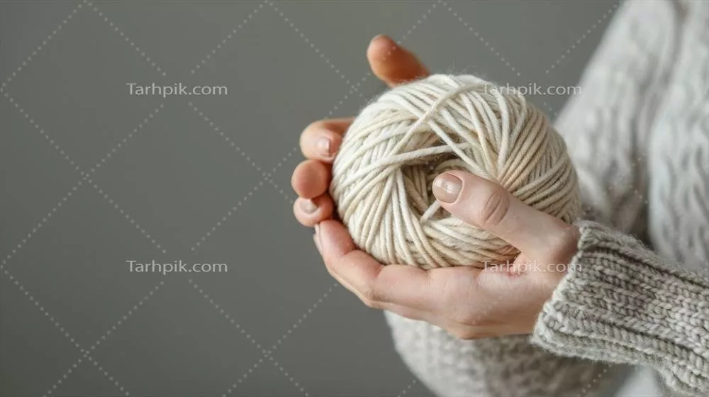 عکس دست holding یک کلاف کاموا با بسته بندی زیبا و مواد با کیفیت بالا