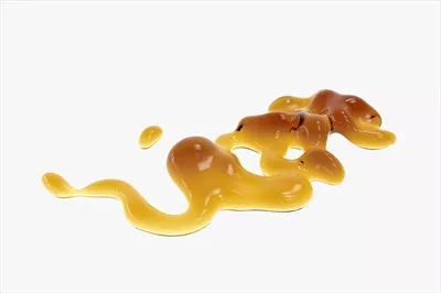 عکس چکیده ای از قطرات عسل طلایی بر روی پس زمینه سفید با طراحی سه بعدی