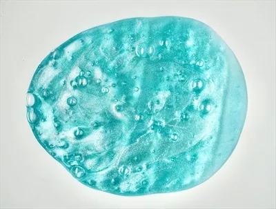 عکس اسباب بازی ژله ای آبی رنگ با بافت حبابی و کشسان بر روی پس زمینه سفید