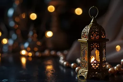 عکس چراغ زینتی عربی با شمع روشن در شب، دعوتی برای ماه مبارک رمضان