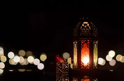 عکس چراغ های زینتی و خرما در پس زمینه ای تاریک برای جشن رمضان