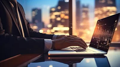 عکس تصویری از دست یک کارمند در حال کار با کامپیوتر مدرن و استراتژی کسب و کار