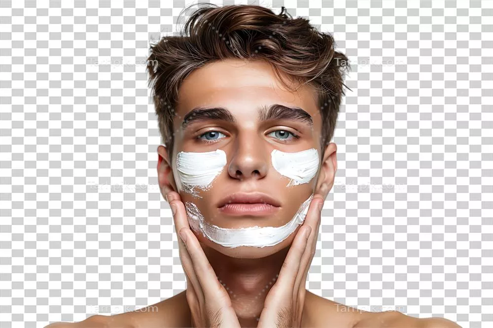 جوانی خوش تیپ با مرطوب کننده بر روی صورتش در پس زمینه شفاف