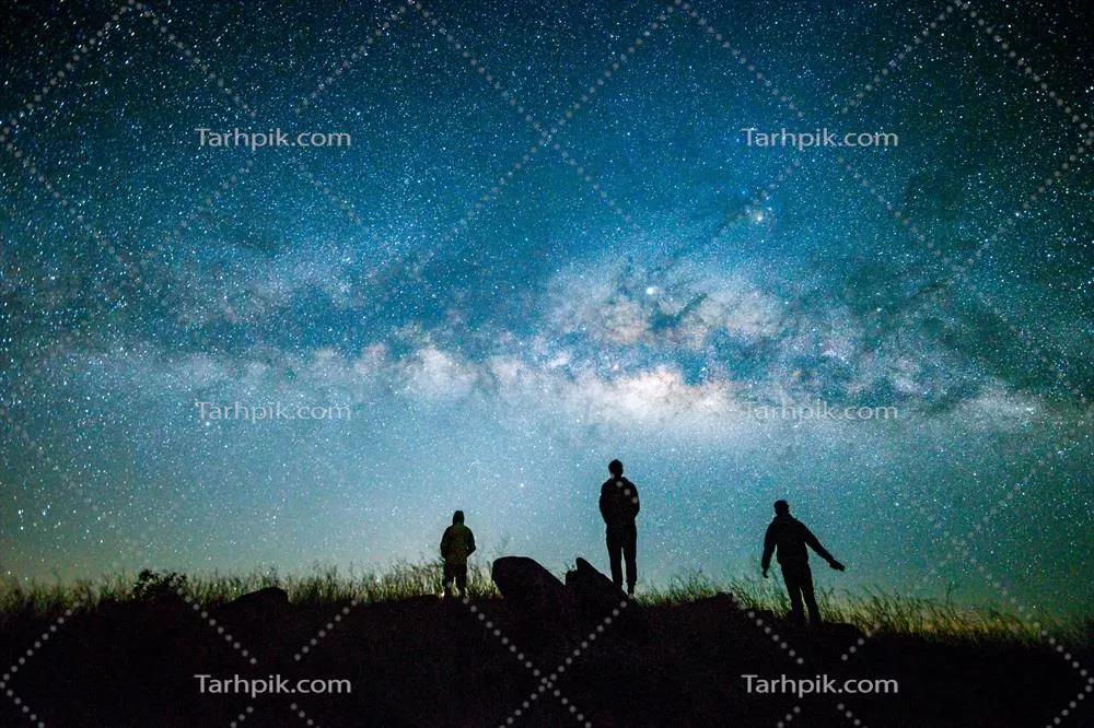 آسمان شب تاریک آبی با کهکشان و سیلوئت مردی ایستاده و خوشحال