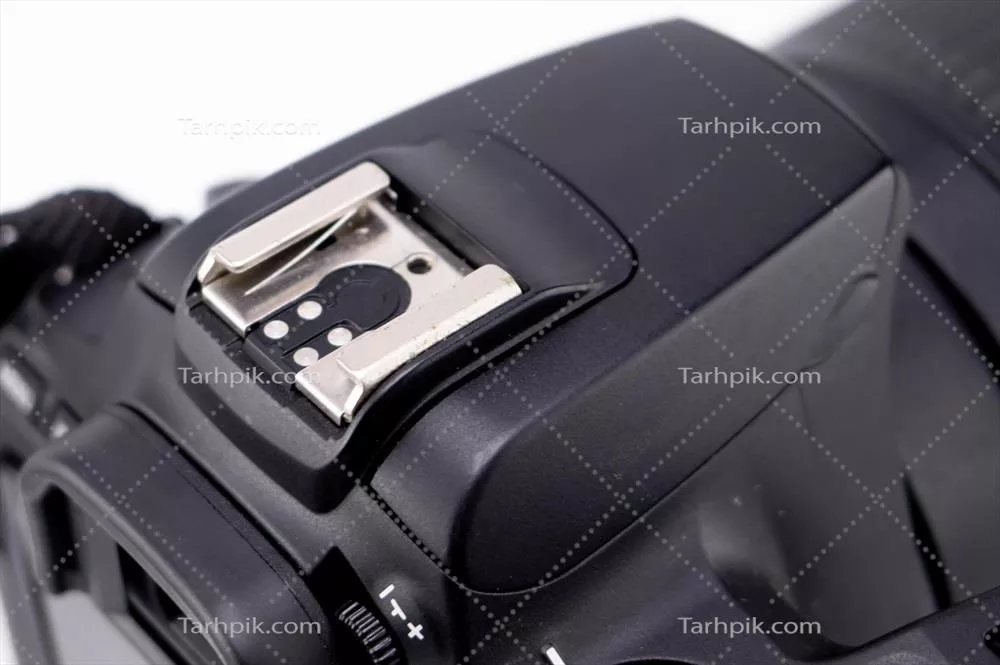 نمای نزدیکی از دوربین DSLR سیاه با پایه داغ روی زمینه سفید