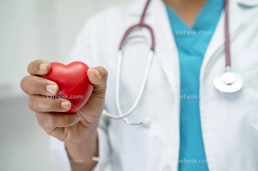 دکتر در حال نگهداری از قلب قرمز در بخش بیمارستانی: مفهوم پزشکی سلامت و قوت