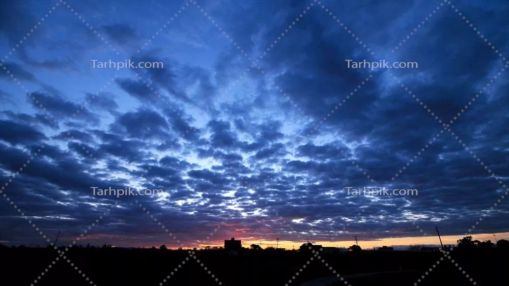 منظره غروب آفتاب با ابرهای غروب و رنگین کمانی دل انگیز