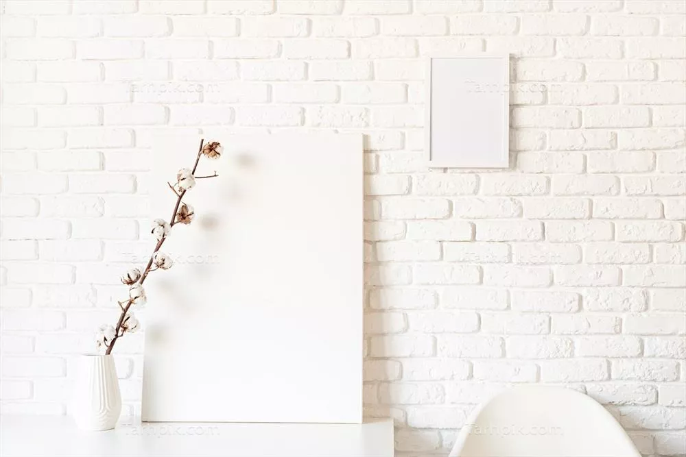 طرح اولیه یک قاب پوستر با شاخه پنبه روی دیوار آجر سفیدی