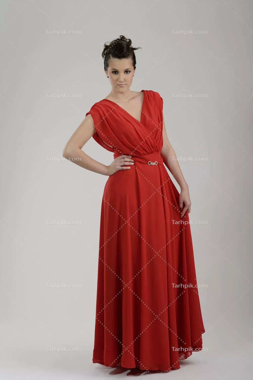 زن با لباس مد روز در استودیو به شکل شیک و مجلل ایستاده است