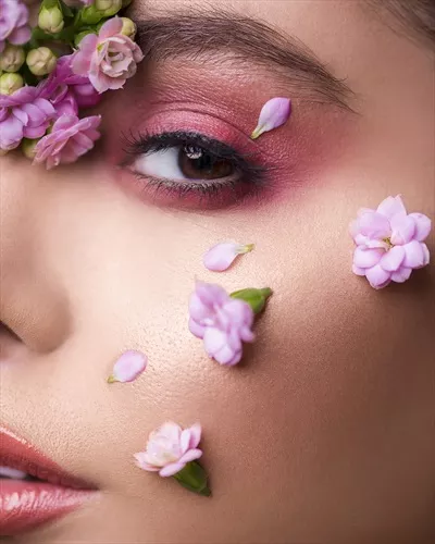 عکس مدل زن با گل هایی که صورتش را تزئین کرده اند